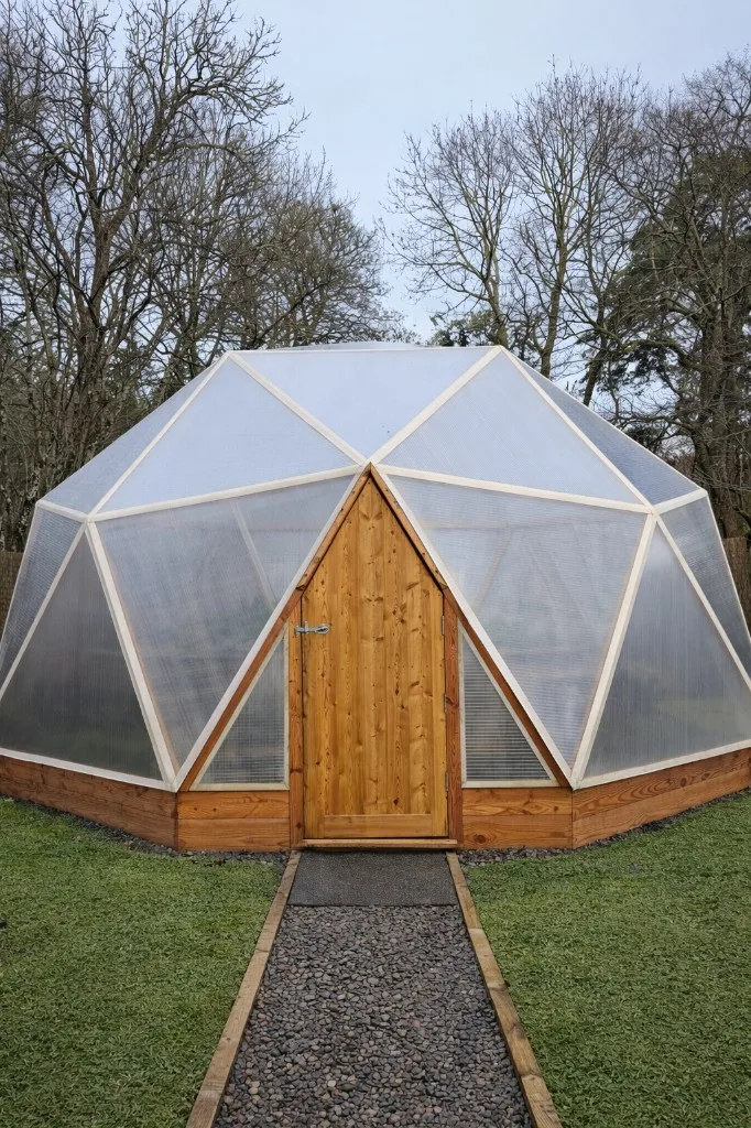 6.27m smallholder's dome - large geodesic greenhouse with timber door and gravel path for families and micro-farms